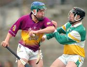 28 March 2004; Paul Carley of Wexford in action against Neville Coughlan of Offaly during the Allianz Hurling League Division 1B match between Offaly and Wexford at St. Brendan's Park in Birr, Offaly. Photo by David Maher/Sportsfile