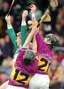 28 March 2004; Brian Whelahan of Offaly in action against Michael Jacob, 12, and Barry Goff of Wexford during the Allianz Hurling League Division 1B match between Offaly and Wexford at St. Brendan's Park in Birr, Offaly. Photo by David Maher/Sportsfile