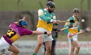 28 March 2004; Brendan Murphy of Offaly in action against M.J. Furlong of Wexford during the Allianz Hurling League Division 1B match between Offaly and Wexford at St. Brendan's Park in Birr, Offaly. Photo by David Maher/Sportsfile