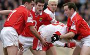 28 March 2004; Mark Harte of Tyrone is tackled by Cork players, from left, Martin Cronin, Graham Canty and Sean O'Brien during the Allianz Football League Division 1A match between Tyrone and Cork at Healy Park in Omagh, Tyrone. Photo by Ray McManus/Sportsfile