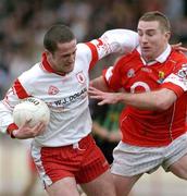 28 March 2004; Stephen O'Neill of Tyrone in action against Eoin Sexton of Cork during the Allianz Football League Division 1A match between Tyrone and Cork at Healy Park in Omagh, Tyrone. Photo by Ray McManus/Sportsfile