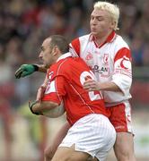 28 March 2004; John Miskella of Cork in action against Owen Mulligan of Tyrone during the Allianz Football League Division 1A match between Tyrone and Cork at Healy Park in Omagh, Tyrone. Photo by Ray McManus/Sportsfile