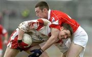 28 March 2004; Enda McGinley of Tyrone in action against Noel O'Leary of Cork during the Allianz Football League Division 1A match between Tyrone and Cork at Healy Park in Omagh, Tyrone. Photo by Ray McManus/Sportsfile