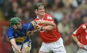 28 March 2004; Michael Byrne of Cork in action against Declan Fanning of Tipperary during the Allianz Hurling League Division 1B match between Cork and Tipperary at Pairc Ui Chaoimh in Cork. Photo by Brendan Moran/Sportsfile