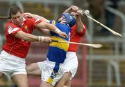 28 March 2004; Paddy O'Brien of Tipperary in action against Diarmuid O'Sullivan, left, and Mark Prendergast of Cork during the Allianz Hurling League Division 1B match between Cork and Tipperary at Pairc Ui Chaoimh in Cork. Photo by Brendan Moran/Sportsfile