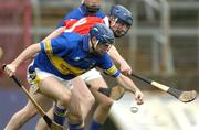 28 March 2004; Eoin Kelly of Tipperary in action against Cian O'Connor of Cork during the Allianz Hurling League Division 1B match between Cork and Tipperary at Pairc Ui Chaoimh in Cork. Photo by Brendan Moran/Sportsfile