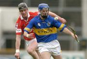 28 March 2004; Colin Morrissey of Tipperary in action against Michael Byrne of Cork during the Allianz Hurling League Division 1B match between Cork and Tipperary at Pairc Ui Chaoimh in Cork. Photo by Brendan Moran/Sportsfile