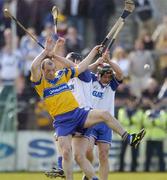 28 March 2004; Ollie Baker of Clare in action against Andy Moloney and Paul Flynn, right, of Waterford during the Allianz Hurling League match between Clare and Waterford at Cusack Park in Ennis, Clare. Photo by Damien Eagers/Sportsfile