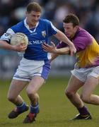 4 April 2004; Brian McDonald of Laois in action against Niall Murphy of Wexford during the Allianz Football League Division 1B Round 7 match between Laois and Wexford at O'Moore Park in Portlaoise, Laois. Photo by Damien Eagers/Sportsfile