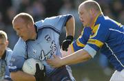 4 April 2004; Shane Ryan of Dublin is tackled by Niall Sheridan of Longford during the Allianz Football League Division 1A Round 7 match between Dublin and Longford at Parnell Park in Dublin. Photo by Pat Murphy/Sportsfile