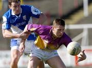 4 April 2004; Robert Hasset of Wexford in action against Kevin Fitzpatrick of Laois during the Allianz Football League Division 1B Round 7 match between Laois and Wexford at O'Moore Park in Portlaoise, Laois. Photo by Damien Eagers/Sportsfile