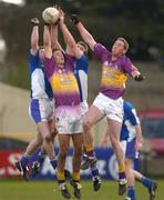 4 April 2004; David Fogerty and Nicky Lambert of Wexford, right, contest a high ball with Noel Garvan and Kevin Fitzpatrick of Laois, left, during the Allianz Football League Division 1B Round 7 match between Laois and Wexford at O'Moore Park in Portlaoise, Laois. Photo by Damien Eagers/Sportsfile