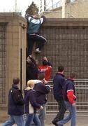 10 April 2004; Munster fans climb the perimeter wall to gain access to the game ahead of the Heineken Cup Quarter-Final match between Munster and Stade Francais at Thomond Park in Limerick. Photo by Ray McManus/Sportsfile