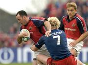10 April 2004; Mike Mullins of Munster is tackled by Remy Martin of Stade Francais during the Heineken Cup Quarter-Final match between Munster and Stade Francais at Thomond Park in Limerick. Photo by Brendan Moran/Sportsfile