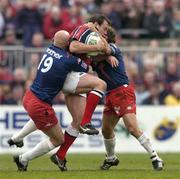10 April 2004; Rob Henderson of Munster is tackled by Christophe Moni, 19, and Diego Dominguez of Stade Francais during the Heineken Cup Quarter-Final match between Munster and Stade Francais at Thomond Park in Limerick. Photo by Ray McManus/Sportsfile