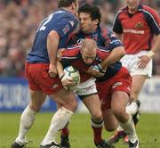 10 April 2004; Peter Stringer of Munster is tackled by Brian Liebenberg, left, and Mathieu Blin of Stade Francais during the Heineken Cup Quarter-Final match between Munster and Stade Francais at Thomond Park in Limerick. Photo by Brendan Moran/Sportsfile