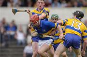 11 April 2004; Diarmaid Fitzgerald of Tipperary is tackled by Niall Gilligan, 13, and Diarmuid McMahon of Tipperary during the Allianz Hurling League Division 1 Group 1 match between Clare and Tipperary at Cusack Park in Ennis, Clare. Photo by Ray McManus/Sportsfile