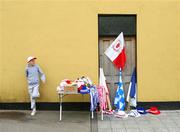 15 July 2007; A young flag seller awaits a customer. Bank of Ireland Ulster Senior Football Championship Final - Tyrone v Monaghan, St Tighearnach's Park, Clones, Co Monaghan. Picture credit: Russell Pritchard / SPORTSFILE
