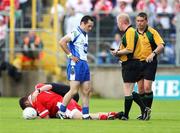 15 July 2007; Tyrone's Phillip Jordan receives treatment while referee Derek Fahy speaks to Monaghan's Stephen Gollogoly. Bank of Ireland Ulster Senior Football Championship Final - Tyrone v Monaghan, St Tighearnach's Park, Clones, Co Monaghan. Picture credit: Russell Pritchard / SPORTSFILE