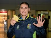 25 November 2014; Team Ireland's Katie Taylor pictured with her gold medal in Dublin Airport on her return from the 2014 AIBA Elite Women's World Boxing Championships in Jeju, Korea. Dublin Airport, Dublin. Picture credit: Barry Cregg / SPORTSFILE