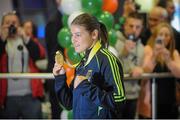 25 November 2014; Team Ireland's Katie Taylor pictured with her gold medal in Dublin Airport on her return from the 2014 AIBA Elite Women's World Boxing Championships in Jeju, Korea. Dublin Airport, Dublin. Picture credit: Cody Glenn / SPORTSFILE