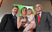 26 November 2014; Roisin McGettigan, with her daughter Hope aged 3, receives her European Indoors 1500m Bronze medal which she won in Turin in 2009 from Ciarán Ó Catháin, left, President of Athletics Ireland, and former President of Athletics Ireland Liam Hennessey during the National Athletics Awards. Crowne Plaza Hotel, Santry, Co. Dublin. Picture credit: Barry Cregg / SPORTSFILE