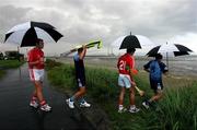 17 July 2007; Dublin footballers Jason Sherlock, second from left, and Ciaran Whelan, right, Cork hurler Tom Kenny, 21, and Cork footballer James Masters, who were announced as Ariel GAA Championship Bright Ambassadors for 2007 arrive for the photocall on Sandymount beach. This summer, Ariel is giving away free exclusive GAA towels with promotional packs. Martello Tower, Sandymount Strand, Dublin. Picture credit: Ray McManus / SPORTSFILE