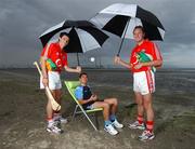 17 July 2007; Dublin footballer Jason Sherlock with Cork hurler Tom Kenny, left, and Cork footballer James Masters, were announced as Ariel GAA Championship Bright Ambassadors for 2007. This summer, Ariel is giving away free exclusive GAA towels with promotional packs. Martello Tower, Sandymount Strand, Dublin. Picture credit: Ray McManus / SPORTSFILE