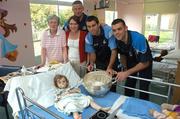 19 July 2007; Dublin players Paul Casey, right, David Henry, second from right, and manager Paul Caffrey, with Mary Kate Costello, age 22 months, from Celbridge, Co. Kildare, who was just back from surgery, Nana Mary Ferriter, from Terenure, left, and Cathrine Costello, Celbridge, Co, Kildare, on a visit to Our Lady's Children's Hospital, Crumlin, Dublin. Picture credit: Stephen McCarthy / SPORTSFILE *** Local Caption ***