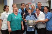 19 July 2007; Dublin players David Henry, left, Paul Casey, and manager Paul Caffrey, with, from left, Anna Daveey, Karen Glenan, Marie Conlon, May O'Sullivan, Keelin Nession, Sharon Gill and Parke Calalany, who are all nurses in St. Joseph's Ward, on a visit to Our Lady's Children's Hospital, Crumlin, Dublin. Picture credit: Stephen McCarthy / SPORTSFILE