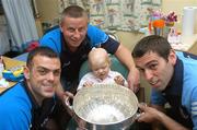 19 July 2007; Dublin players Paul Casey, left, David Henry, right, and manager Paul Caffrey with Ciara Tucker, age 4, from Athy, Co. Kildare, on a visit to Our Lady's Children's Hospital, Crumlin, Dublin. Picture credit: Stephen McCarthy / SPORTSFILE