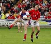 21 July 2007; Stuart Reynolds, Louth, in action against James Masters, Cork. Bank of Ireland All-Ireland Senior Football Championship Qualifier, Round 3, Louth v Cork, O'Moore Park, Portlaoise, Co. Laois. Picture credit: Ray McManus / SPORTSFILE