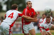 21 July 2007; John Miskella, Cork, beats the tackles of John Heary, 4, and Alan Page, Louth. Bank of Ireland All-Ireland Senior Football Championship Qualifier, Round 3, Louth v Cork, O'Moore Park, Portlaoise, Co. Laois. Picture credit: Stephen McCarthy / SPORTSFILE