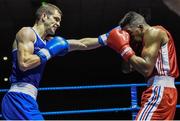 28 November 2014; Adam Nolan, Ireland, left, exchanges punches with Daouda Sangare, France, during their 69kg bout. Elite Boxing International, Ireland v France, National Stadium, Dublin. Picture credit: Ramsey Cardy / SPORTSFILE