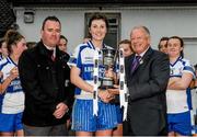 29 November 2014; Castleisland Desmonds captain Lorraine Scanlon is presented with the cup by Ladies Gaelic Football Association president Pat Quill, right, and Paul O'Loughlin, from Tesco Ennis, left. TESCO HomeGrown Intermediate Ladies Football Club Championship Final, Castleisland Desmonds, Kerry v Clonbur, Galway. Corofin, Co. Clare. Picture credit: Diarmuid Greene / SPORTSFILE
