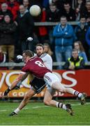 30 November 2014; Connor O'Donnell, Omagh St Enda's, scores a point despite the attempted block of Patsy Bradley, Slaughtneil. AIB Ulster GAA Football Senior Club Championship Final, Omagh St Enda's v Slaughtneil, Athletic Grounds, Armagh. Picture credit: Oliver McVeigh / SPORTSFILE