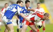 28 July 2007; Kevin McCloy, Derry, in action against Kevin Fitzpatrick and Brendan Quigley, Laois. Bank of Ireland All-Ireland Senior Football Championship Qualifier, Round 3, Laois v Derry, Kingspan Breffni Park, Cavan. Picture credit: Ray Lohan / SPORTSFILE