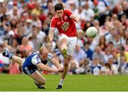 15 June 2014; Sean Cavanagh, Tyrone,  with a shot on goal dispite the attempted block of Dick Clerkin, Monaghan. Ulster GAA Football Senior Championship, Semi-Final, Monaghan v Tyrone, St Tiernach's Park, Clones, Co. Monaghan. Picture credit: Oliver McVeigh / SPORTSFILE