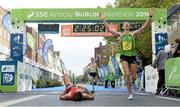 27 October 2014; Eoin Flynn, Ireland, right, celebrates crossing the line as Thomas Cornthwaite, from Lanchashire, England, catches his breath after the SSE Airtricity Dublin Marathon 2014. Merrion Square, Dublin. Picture credit: Pat Murphy / SPORTSFILE