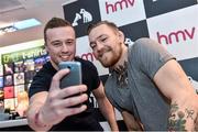 6 December 2014; UFC star Conor ‘The Notorious’ McGregor, right, pictured with Ryan McDonnell, from Ballinteer, Dublin, in HMV Grafton Street during a signing of his new DVD 'Notorious'. HMV, Grafton Street, Dublin. Picture credit: Ramsey Cardy / SPORTSFILE