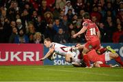 6 December 2014; Darren Cave, Ulster, is tackled by Michael Tagicakibau, Scarlets, while diving over the line for his side's opening try. European Rugby Champions Cup 2014/15, Pool 3, Round 3, Ulster v Scarlets, Kingspan Stadium, Ravenhill Park, Belfast, Co. Antrim. Picture credit: Oliver McVeigh / SPORTSFILE