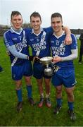 6 December 2014; St Mary's players Denis Daly, Paul O'Donoghue and Daniel Daly with the Jack Murphy Cup following their South Kerry Championship Final victory. South Kerry Championship Final Replay, St Mary's v Waterville. Con Keating Park, Cahersiveen, Co. Kerry. Picture credit: Stephen McCarthy / SPORTSFILE