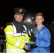 5 December 2014; Garda Assistant Commissioner John Twomey presents Adam Byrne, Darndale, with the cup after his side won the Europa League under 16 competition. Late Night Leagues Dublin Metropolitan Region Finals, Irishtown Stadium, Ringsend, Dublin. Picture credit: Piaras O Midheach / SPORTSFILE