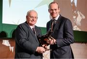 8 December 2014; Tom Hogan receiving the Outstanding Achievement award from Simon Coveney, TD, Minister for Agriculture, Food and the Marine. Horse Racing Ireland Awards. Leopardstown Racecourse, Leopardstown, Co. Dublin. Picture credit: Barry Cregg / SPORTSFILE