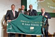 8 December 2014; Paddy Power, left, with brother Willie, right, and trainer Eddie Lynam receiving the Horse of the Year award 2014, for Sole Power, from Simon Coveney, TD, Minister for Agriculture Food and the Marine. Horse Racing Ireland Awards. Leopardstown Racecourse, Leopardstown, Co. Dublin. Picture credit: Barry Cregg / SPORTSFILE