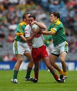 4 August 2007; Ryan Mellon, Tyrone, is tackled by Meath players Chris O'Connor, left, and Seamus Kenny. Bank of Ireland Football Championship Quarter Final, Tyrone v Meath, Croke Park, Dublin. Picture Credit; Ray McManus / SPORTSFILE