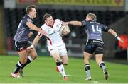 20 December 2014; Darren Cave, Ulster, is tackled by Ashley Beck and Hanna Dirksen, Ospreys. Guinness PRO12, Round 10, Ospreys v Ulster, Liberty Stadium, Swansea, Wales. Picture credit: Steve Pope / SPORTSFILE