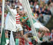 19 August 2007; Graham Geraghty, Meath, is held by Kieran O'Connor, Cork, in the back of the net as an umpire waves a Meath wide. Bank of Ireland All-Ireland Senior Football Championship Semi-Final, Meath v Cork, Croke Park, Dublin. Picture credit; Brendan Moran / SPORTSFILE *** Local Caption ***