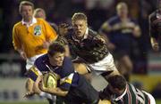 15 January 2000; Brian O'Driscoll of Leinster is tackled by Tim Stimpson, 17, and Lewis Moody of Leicester during the Heineken Cup Pool 1 Round 6 match between Leicester and Leinster at Welford Road in Leicester, England. Photo by Brendan Moran/Sportsfile