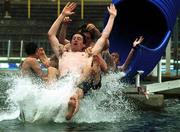 20 July 1999; Players Clive Delaney, Dean Delaney and Richie Baker enjoy the waterslide at the Simhallen complex in Linkoping after a Republic of Ireland U18 Training Session at Karlsbergsplan in Linkoping, Sweden. Photo by David Maher/Sportsfile